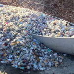 Photo of a canoe filled with discarded nip bottles