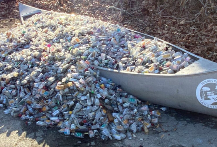 Photo of a canoe filled with discarded nip bottles