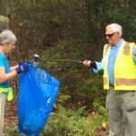 Picture of John and Frances Topping picking up litter