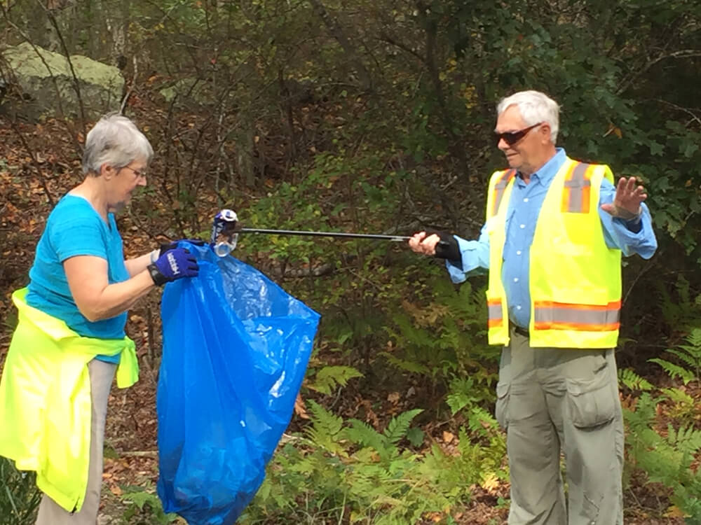 Picture of John and Frances Topping picking up litter
