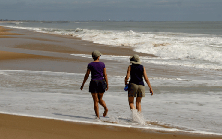 Photo of two women walking on East Beach